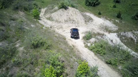 Drone of Jeep liberty 4x4 driving offroad on some sand dunes