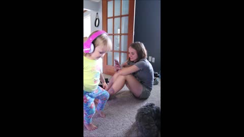 Toddler humorously dances with wireless headphones