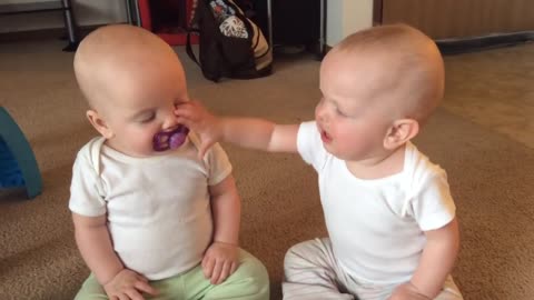 #Twin baby girls fight over pacifier