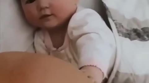 Mother and baby play a tik talk with cute smile