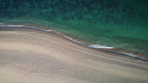 View of the turquoise blue sea from a sunny beach