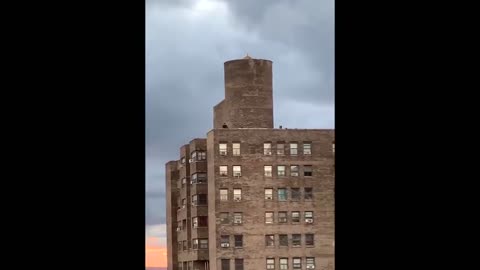 Daredevil New Yorker runs around rooftop edge of apartment building