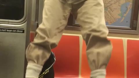 Older guy doing pull ups on subway