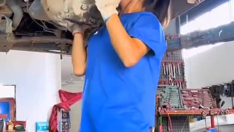 The girl who fixes cars. He is a strong man. Very cool.