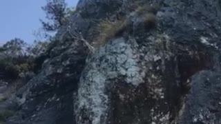 Air running big cliff jump filmed from below