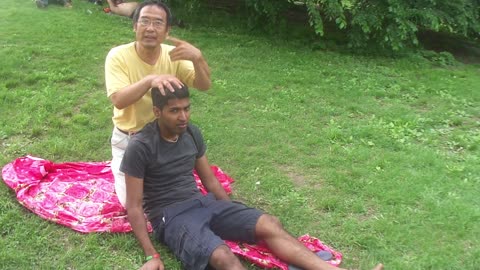 Luodong Massages Indian Man On The Grass