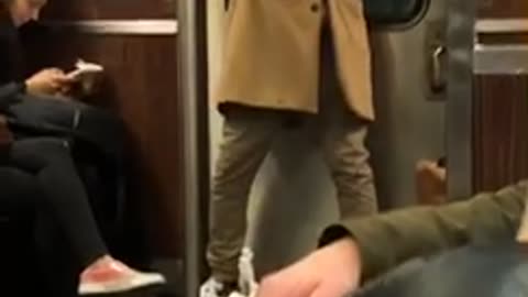 Guy wears vr headset on subway train and waves his arms around