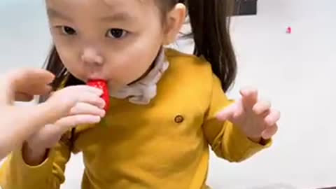 baby eating strawberry