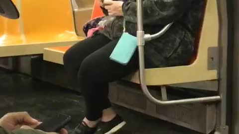 Woman on subway rubs egg on skin