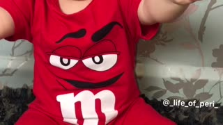 baby eating m&m's and dancing