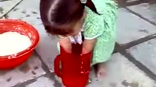 A very Very cute little girl helping her mother at home