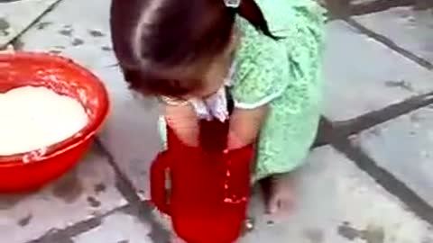 A very Very cute little girl helping her mother at home