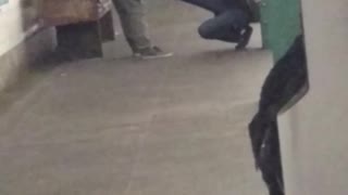 Two people exercising on subway station platform