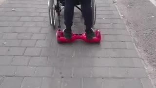 Hoverboarding whilst pushing a guy in a wheelchair