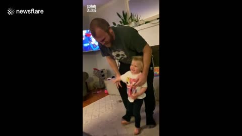 Toddler immediately topples over after been spun around room by dad