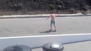 Shirtless guy blue white stripe shorts skateboarding street