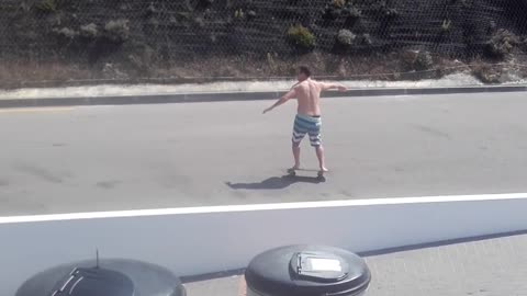 Shirtless guy blue white stripe shorts skateboarding street