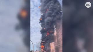 Flames engulf skyscraper in China