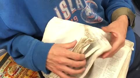 New york islanders blue sweater guy sifting through old book pages