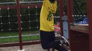 Yellow shirt kid falls off monkey bars