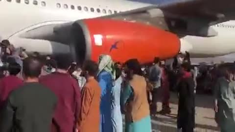 Hundreds of Afghans crowd into a plane