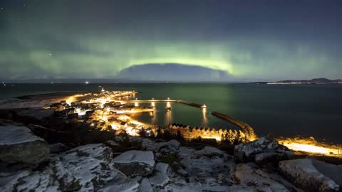 norwegian coast village with northern lights