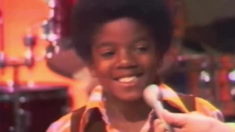 Michael Jackson going through the Jackson 5 band as a 9 year old on stage