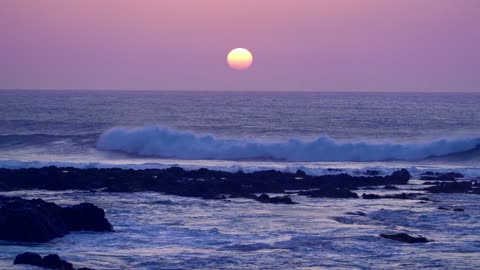 Sunset on the waves of ocean