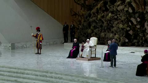 Small boy approaches Pope Francis during audience