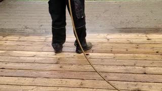 Hard work power washing a deck for stain