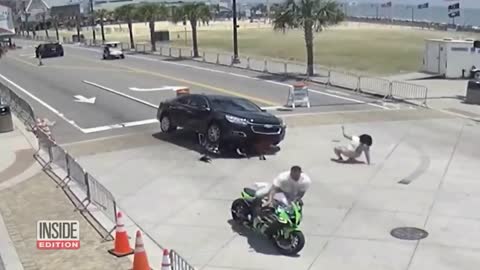Good Samaritans Race to Lift Car off Motorcyclist