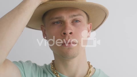 Portrait Of Young Man Putting A Hat On, Looks At Front And Then, Moves His Head 2