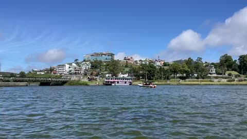 Boat on Gregory Lake to the bridge under the clouds. Nuwara Eliya, Sri Lanka