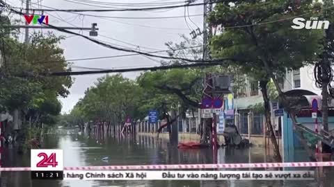 Tourists wade through floodwater as Vietnam's Da Nang is battered by rain