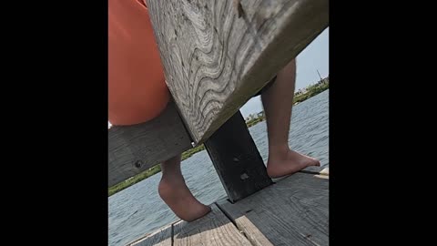Candid Young adult male soles on pier