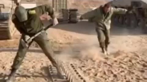 Israeli Soldier Hammering Tank Treads Together