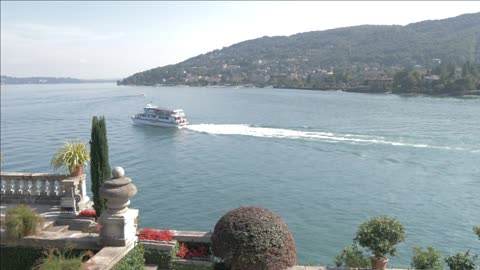 floral fountains and boat on lake maggiore isola bella borromean islands italy
