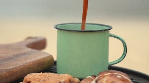 A Person Pouring Hot Coffee in a Cup