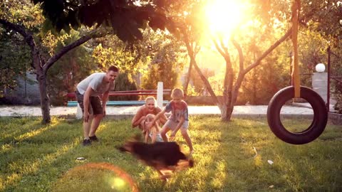 Family playing with a dog in the garden