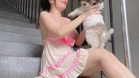 Girl and cute baby dog playing game