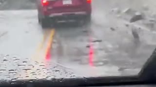 Rocks fall on car at