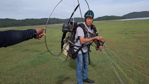 A 69-year-old man flies a paramotor for us to watch.