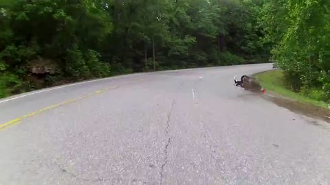 Motorcycle rider loses control during tight turn