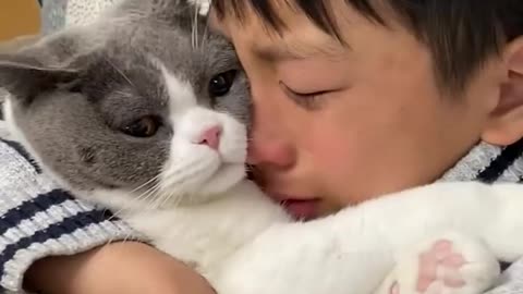 This kid and his cat have such a spec...