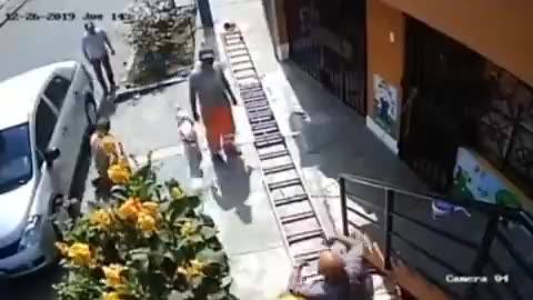 Man in wheelchair shakes painter's ladder