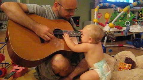 Baby Rocks Out While Dad Plays The Guitar