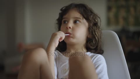 Portrait Little Boy Eating Sweet Lollipop Sitting White cchair