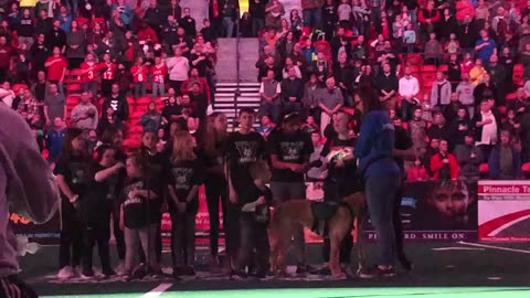 Clemmie sings the National Anthem at a Green Bay Blizzards football game.