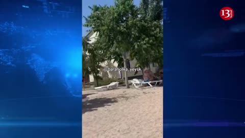 Relaxing on the beach, Russians watch Russian Su-25 fighter jet crash into the sea