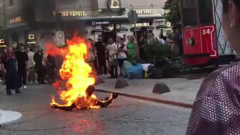 Man wearing a Grim reaper costume set himself on fire in front of the Galata Tower in Istanbul